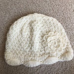 Knit winter hat with crochet flower